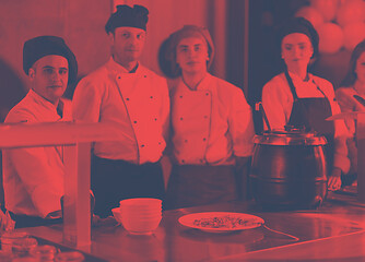 Image showing chefs in the kitchen presenting dish of tasty meal