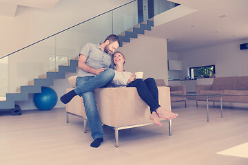 Image showing romantic couple on the sofa watching television