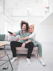 Image showing Young couple on the sofa watching television