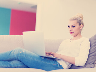 Image showing Young woman using laptop at home