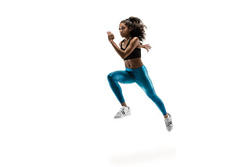 Image showing Young african woman running or jogging isolated on white studio background.