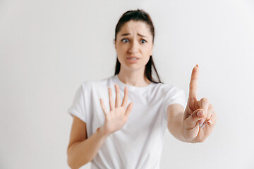 Image showing Woman\'s hand with finger on gray background