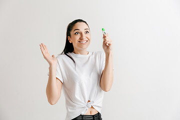 Image showing Smiling young woman looking on pregnancy test