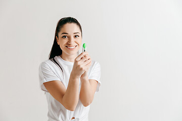 Image showing Smiling young woman looking on pregnancy test