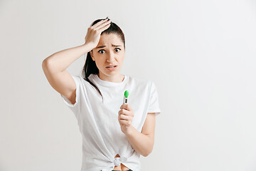 Image showing Young woman looking on pregnancy test