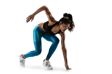 Image showing Young african woman running or jogging isolated on white studio background.