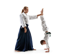 Image showing Man and teen boy fighting at aikido training in martial arts school