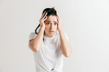 Image showing Woman having headache. Isolated over gray background.