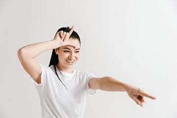 Image showing Losers go home. Portrait of woman showing loser sign over forehead