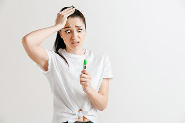 Image showing Young woman looking on pregnancy test