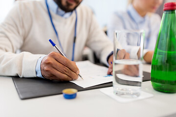 Image showing businessman with papers at business conference