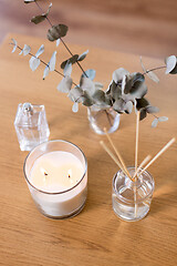 Image showing aroma reed diffuser, burning candle and perfume