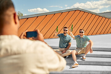 Image showing man photographing friends drinking beer on street