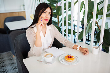 Image showing asian woman with notebook and coffee at cafe