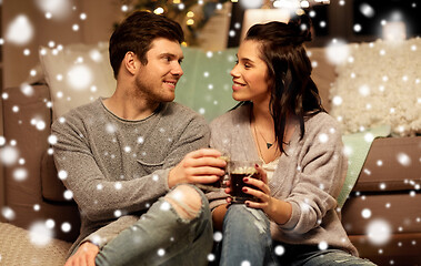 Image showing happy couple drinking coffee and eating at home