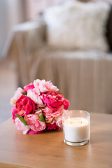 Image showing burning fragrance candle and flower bunch at home