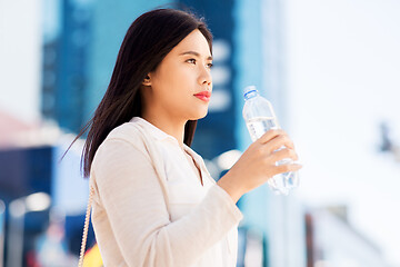 Image showing asian woman drinking water from bottle in city