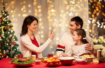 Image showing happy family taking picture at christmas dinner