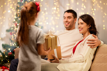 Image showing happy family with christmas present at home