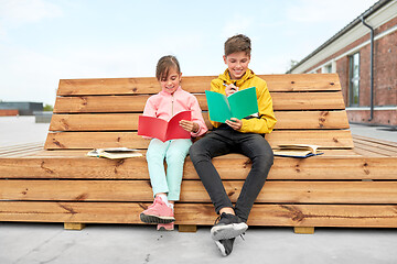 Image showing school children with notebooks sitting on bench