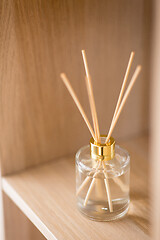 Image showing aroma reed diffuser on wooden shelf