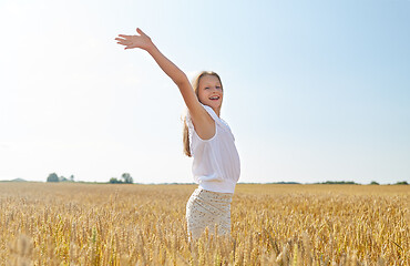Image showing happy smiling young girl on cereal field in summer