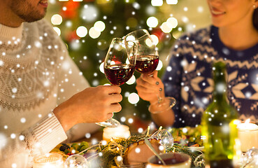 Image showing happy couple drinking red wine at christmas dinner