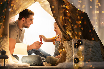 Image showing family playing tea party in kids tent at home