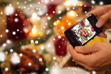 Image showing hands photographing food at christmas dinner