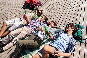 Image showing friends drinking beer and cider on wooden terrace