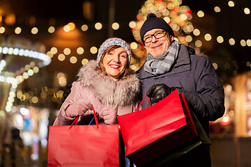 Image showing old couple at christmas market with shopping bags