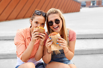 Image showing teenage girls or friends eating burgers outdoors