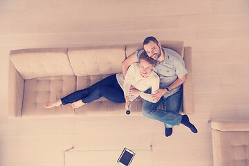 Image showing romantic couple on the sofa watching television top view