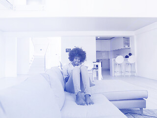 Image showing african american woman at home using digital tablet