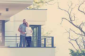 Image showing couple enjoying morning coffee on balcony