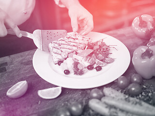 Image showing cook chef decorating garnishing prepared meal