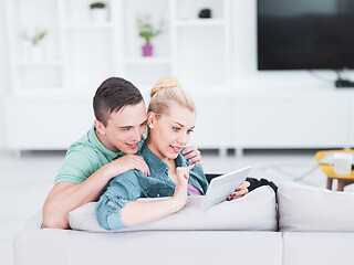 Image showing couple relaxing at  home with tablet computers