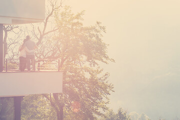 Image showing couple enjoying morning coffee on balcony