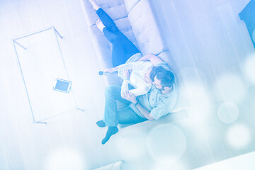 Image showing romantic couple on the sofa watching television top view