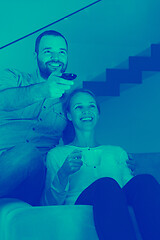 Image showing romantic couple on the sofa watching television