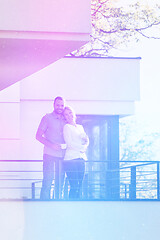 Image showing couple enjoying morning coffee on balcony