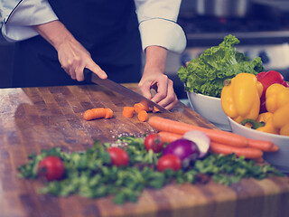Image showing chef hands cutting carrots