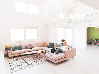 Image showing Young couple on the sofa watching television