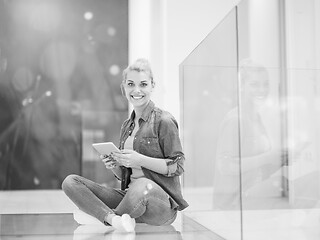 Image showing young woman using tablet computer on the floor