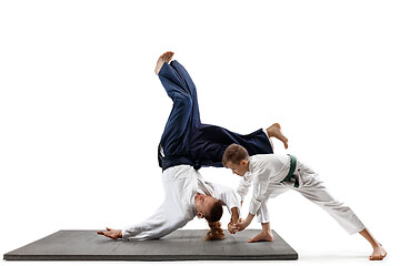 Image showing Man and teen boy fighting at aikido training in martial arts school