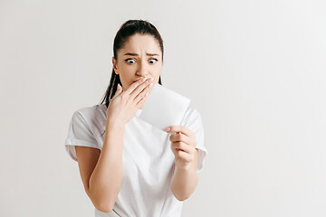 Image showing Young woman with a sad expression lost a bet