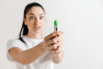 Image showing Smiling young woman looking on pregnancy test