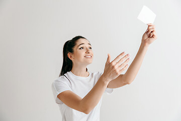 Image showing Young woman with a surprised expression won a bet