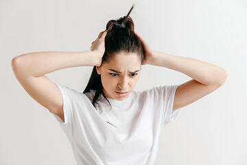 Image showing Woman having headache. Isolated over gray background.