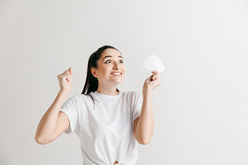 Image showing Young woman with a surprised expression won a bet